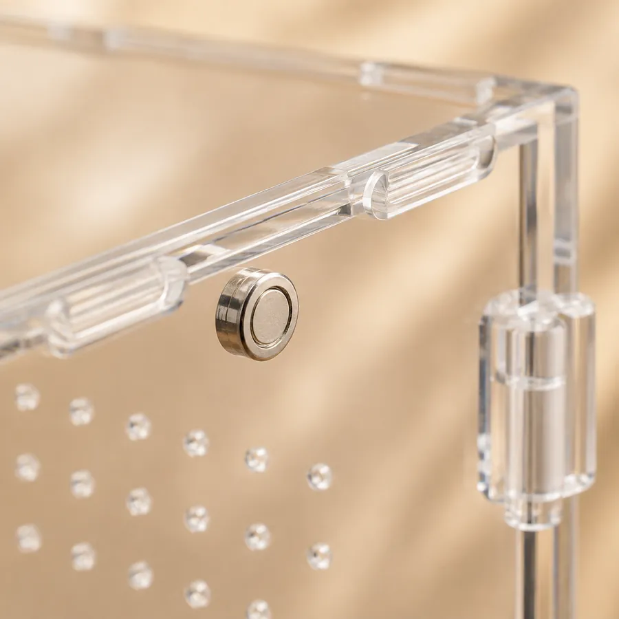 Close-up of the magnetic catch that holds an acrylic enclosure door closed