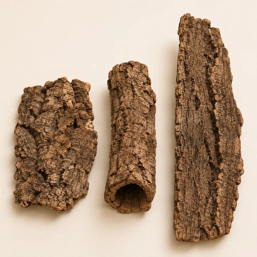 Three pieces of cork bark, a flat slab, a tube and a curved arch, laid out before going into an enclosure