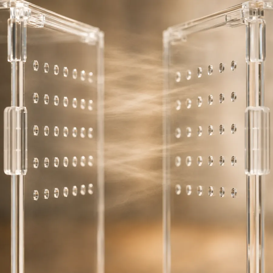 Two ventilated acrylic panels facing each other, the openings that let air travel across an enclosure